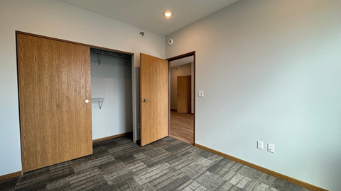 a living room with two doors and a door to a closet