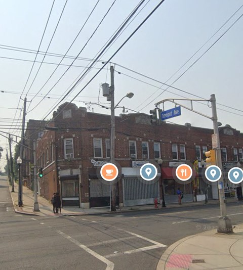 a city street with a brick building and street signs