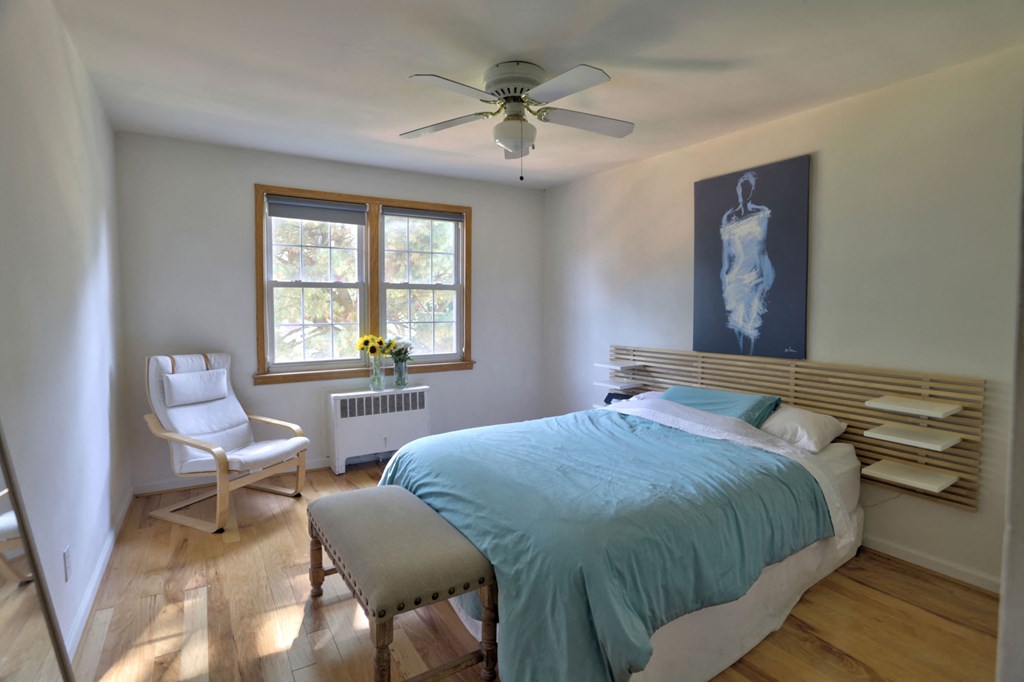 a bedroom with a bed and a ceiling fan