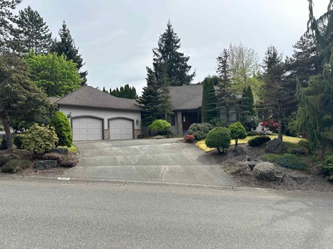 a house with a driveway and a garage door