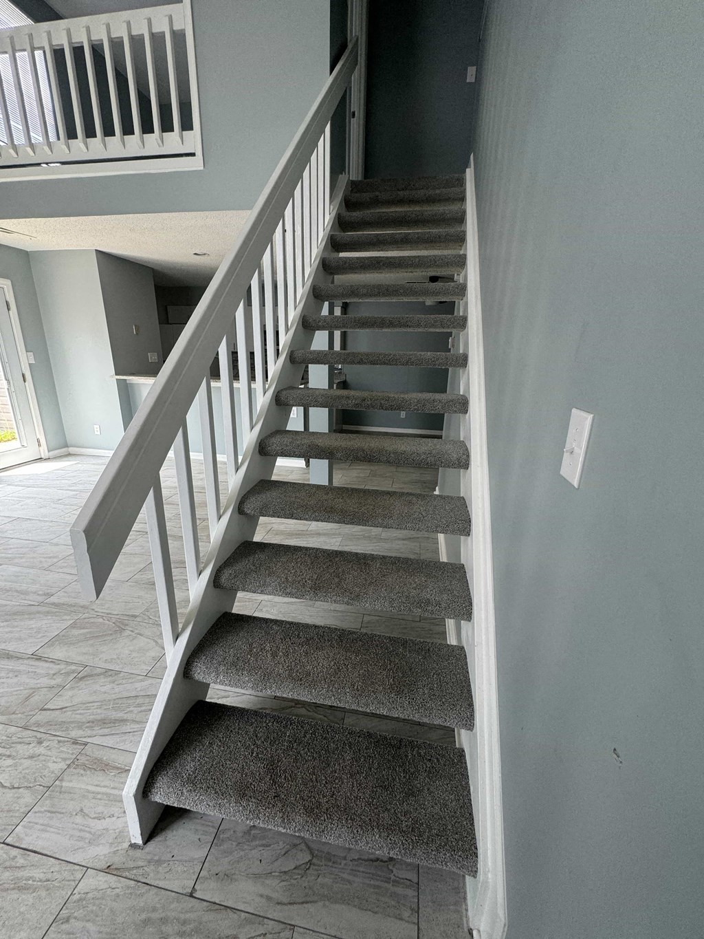 an image of a staircase with carpeted stairs