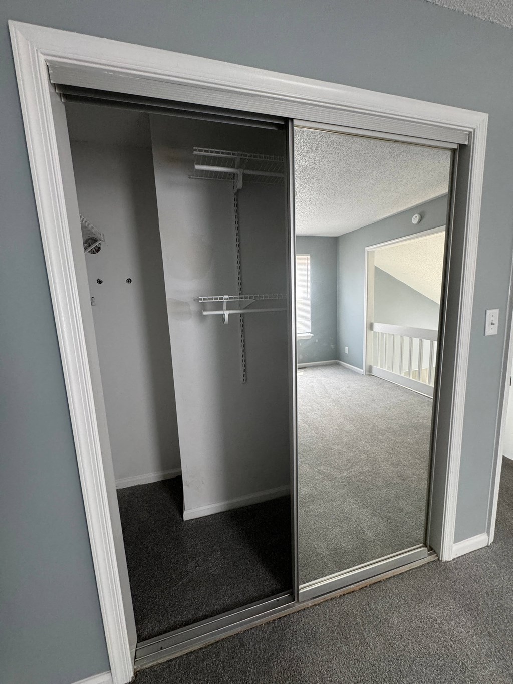 a large mirror in a room with a closet