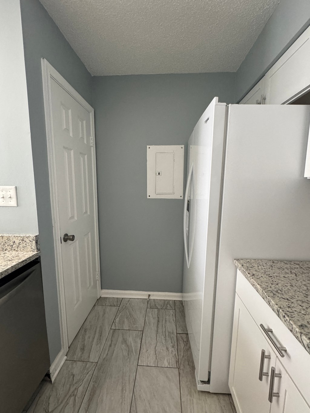 a kitchen with a refrigerator and a door