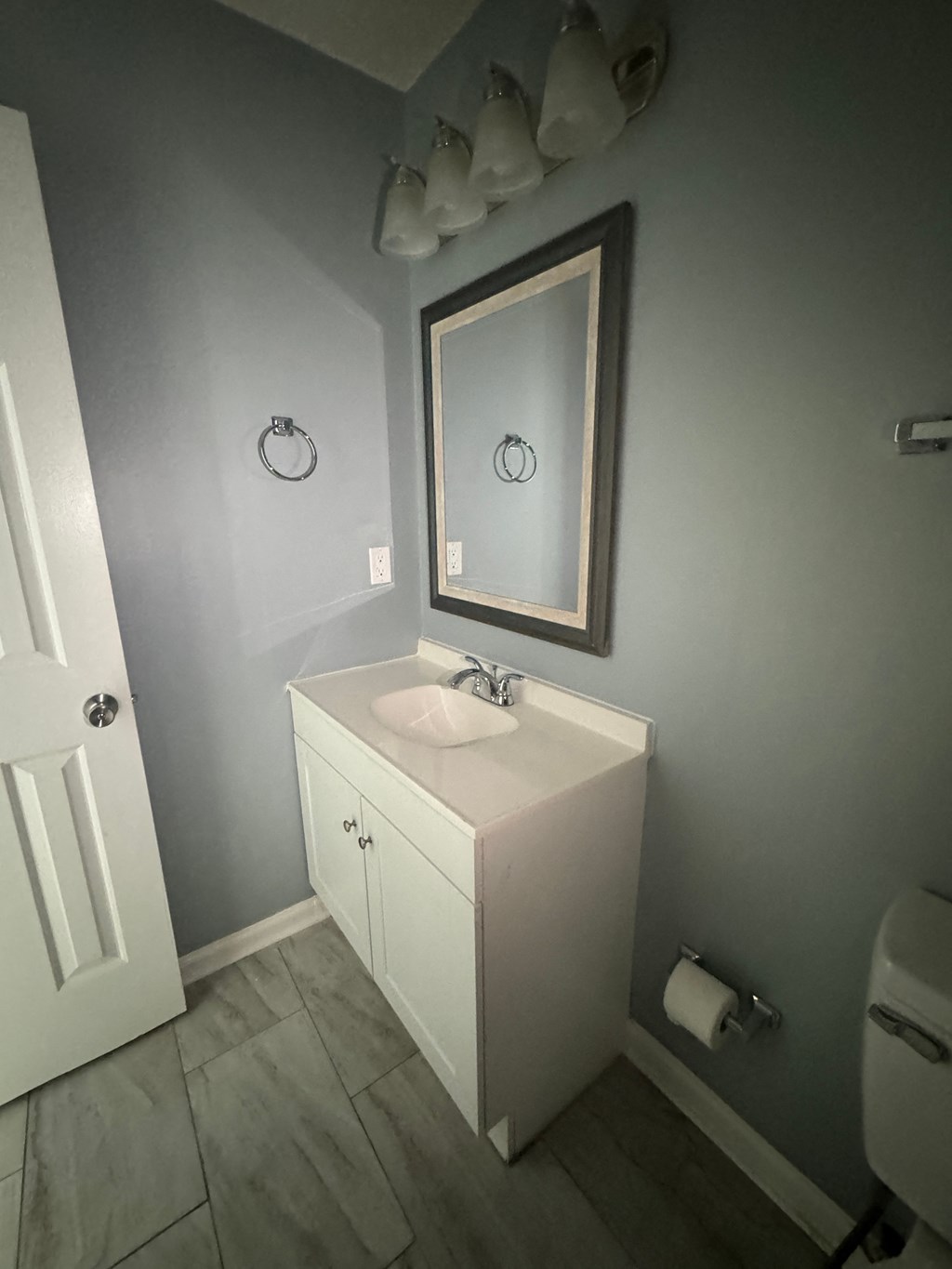 a small bathroom with a sink and a mirror