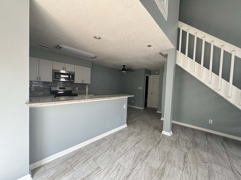 a view of the kitchen and living room from the stairs