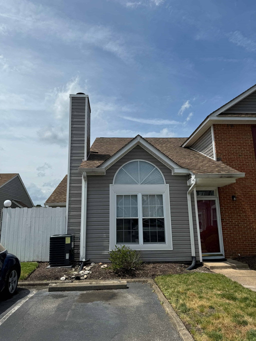 a house with a white window and a white fence