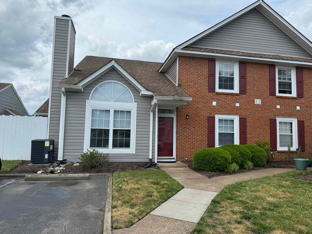 a house with a sidewalk in front of it
