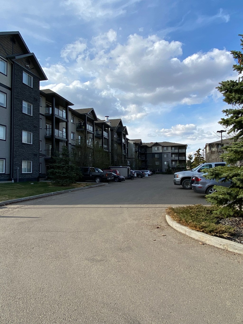 an empty street in front of an apartment building