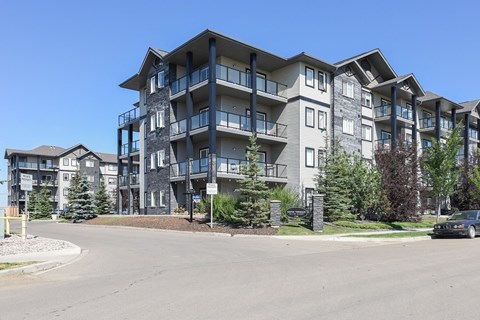 an apartment building on the corner of a street