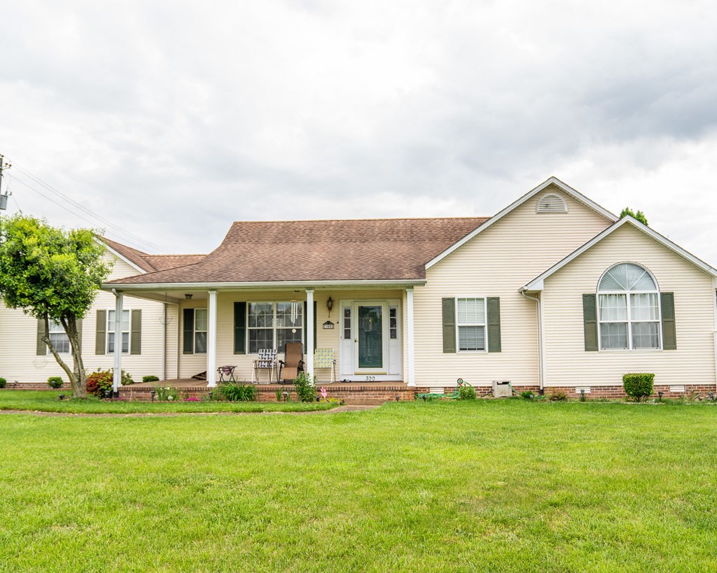 a white house with a lawn in front of it