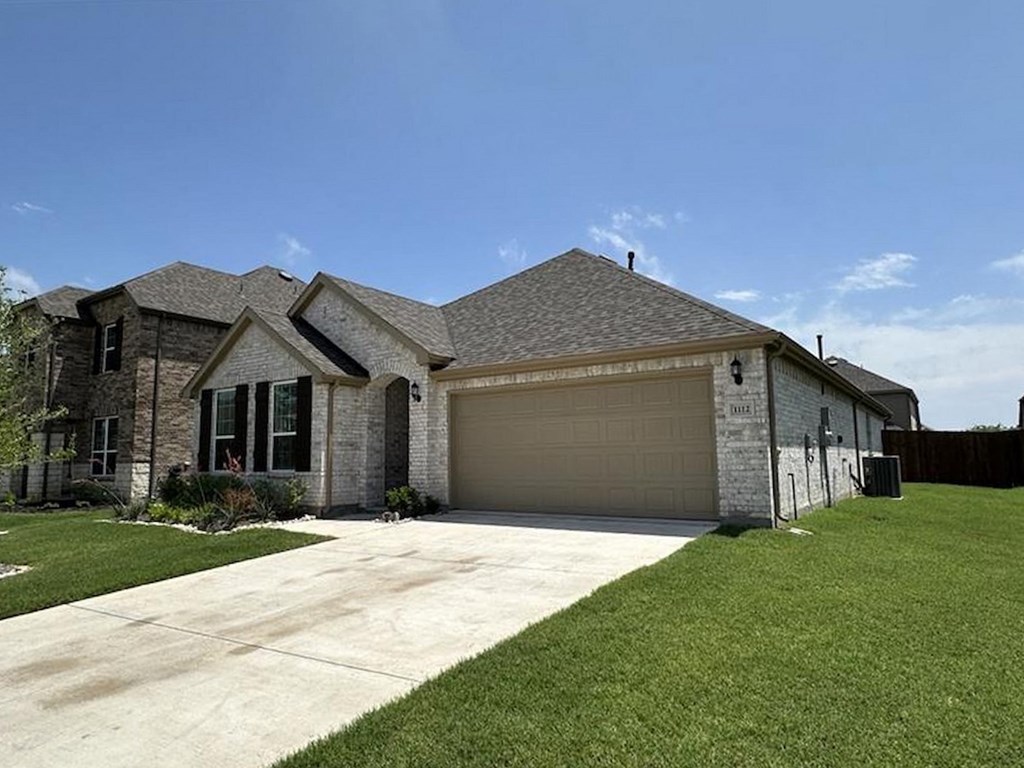 a house with a driveway and a garage door