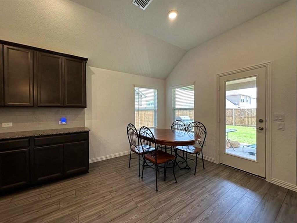 a kitchen and dining room with a table and chairs