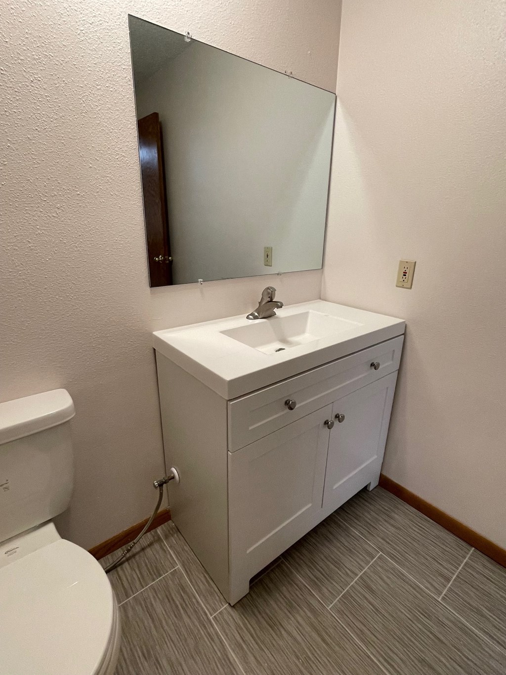 a bathroom with a sink and a toilet and a mirror