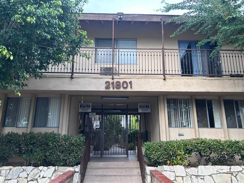 The image shows the front of a building with the number 21801 on it.