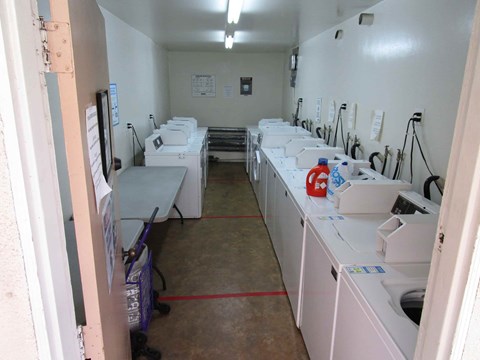 A laundromat with rows of washers and dryers.
