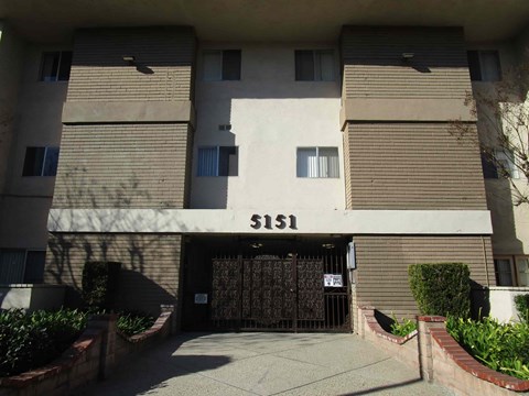 The image shows a building with the number 151 on it.