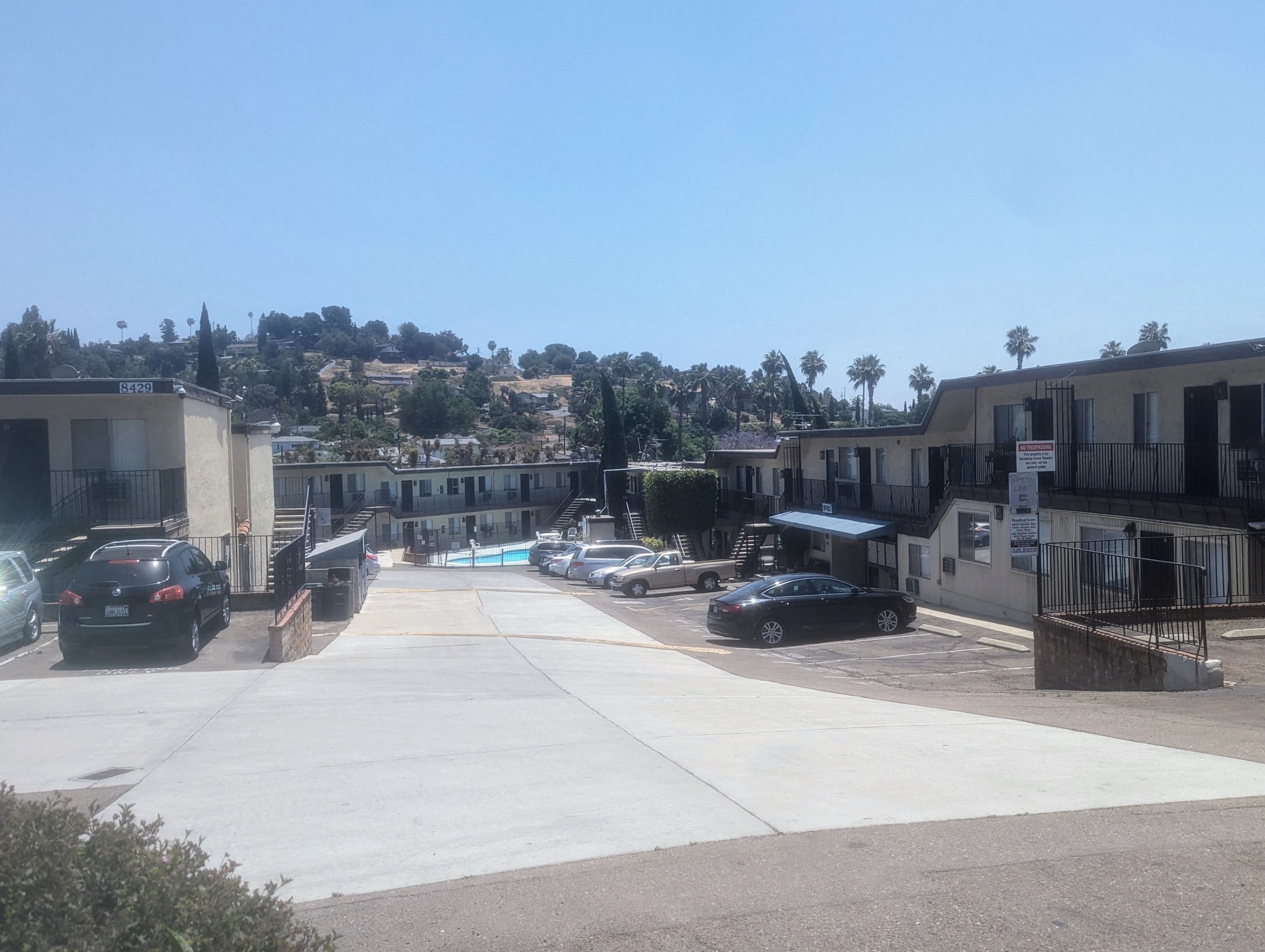 a city street with houses and a hill in the background