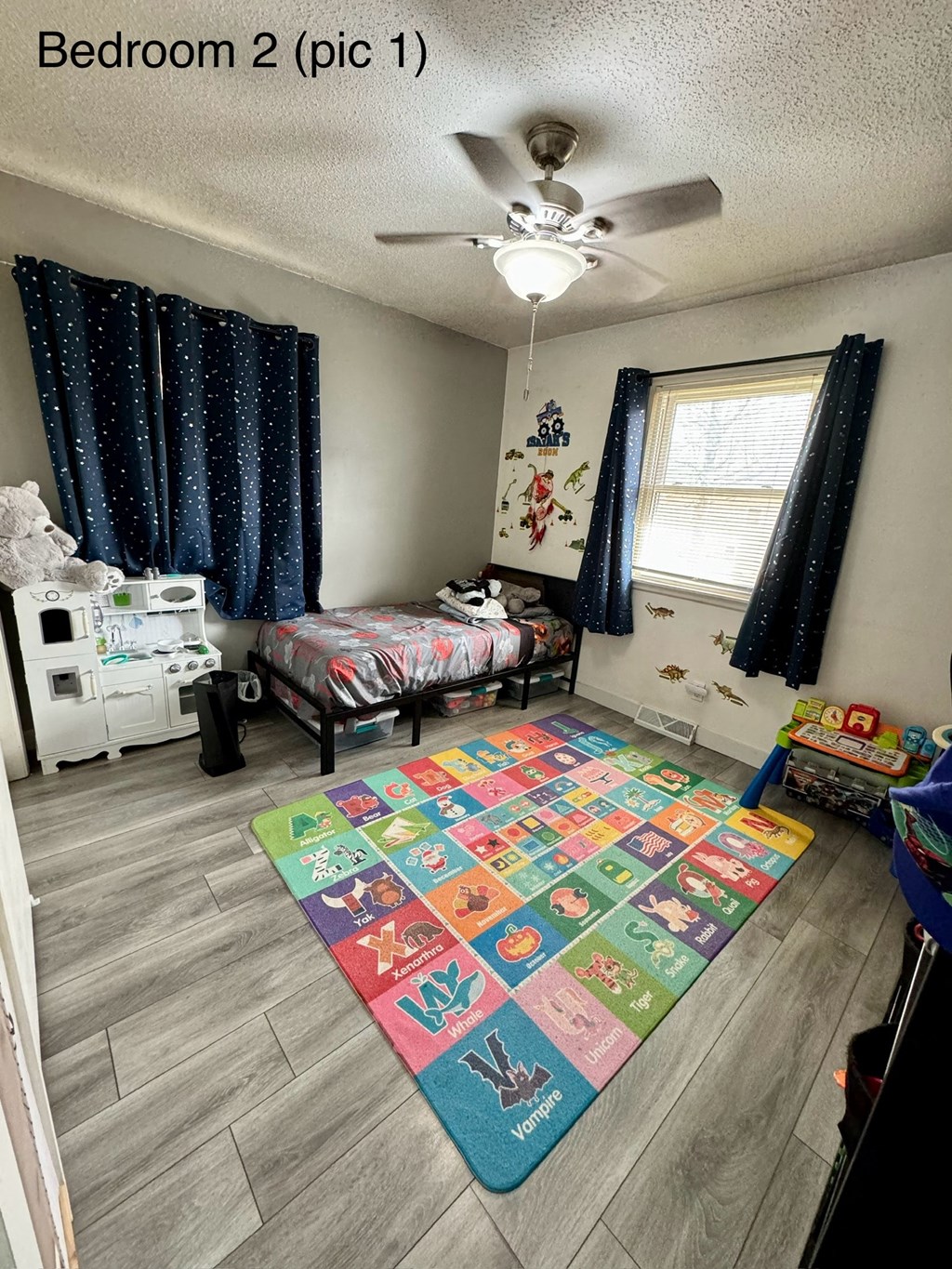 a bedroom with a rug in the middle of the floor