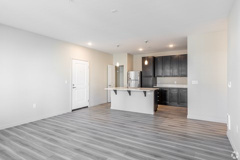 A kitchen with a white countertop and black cabinets.