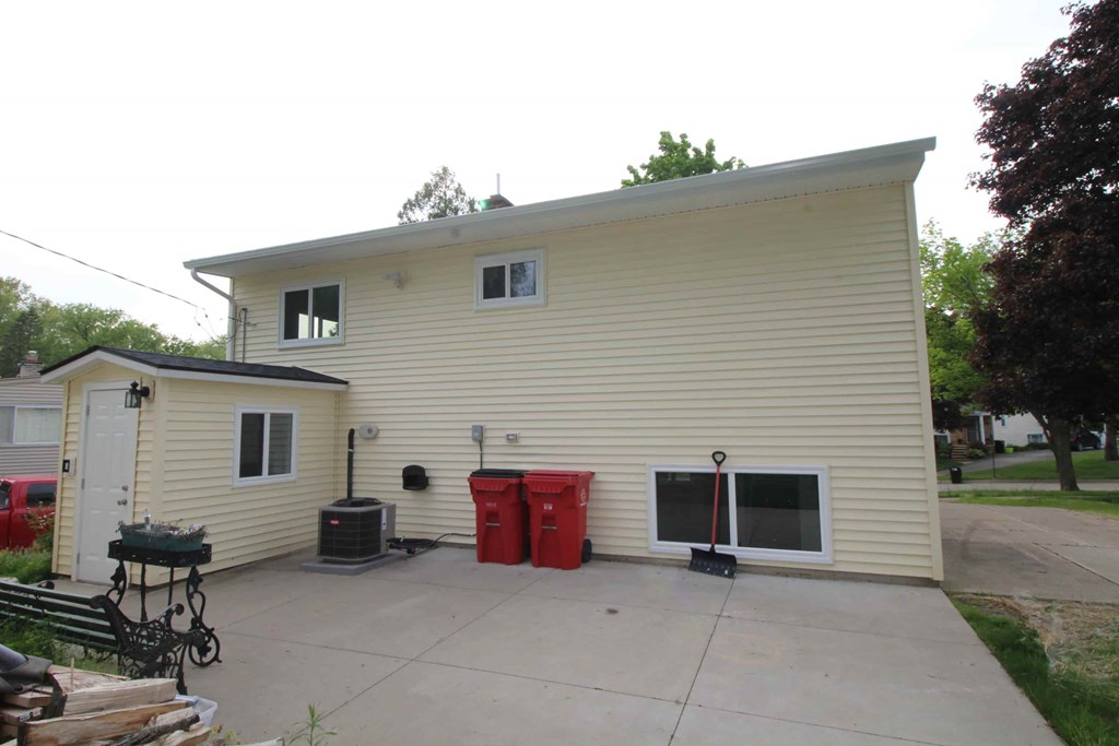 a view of the front of a white house with a patio