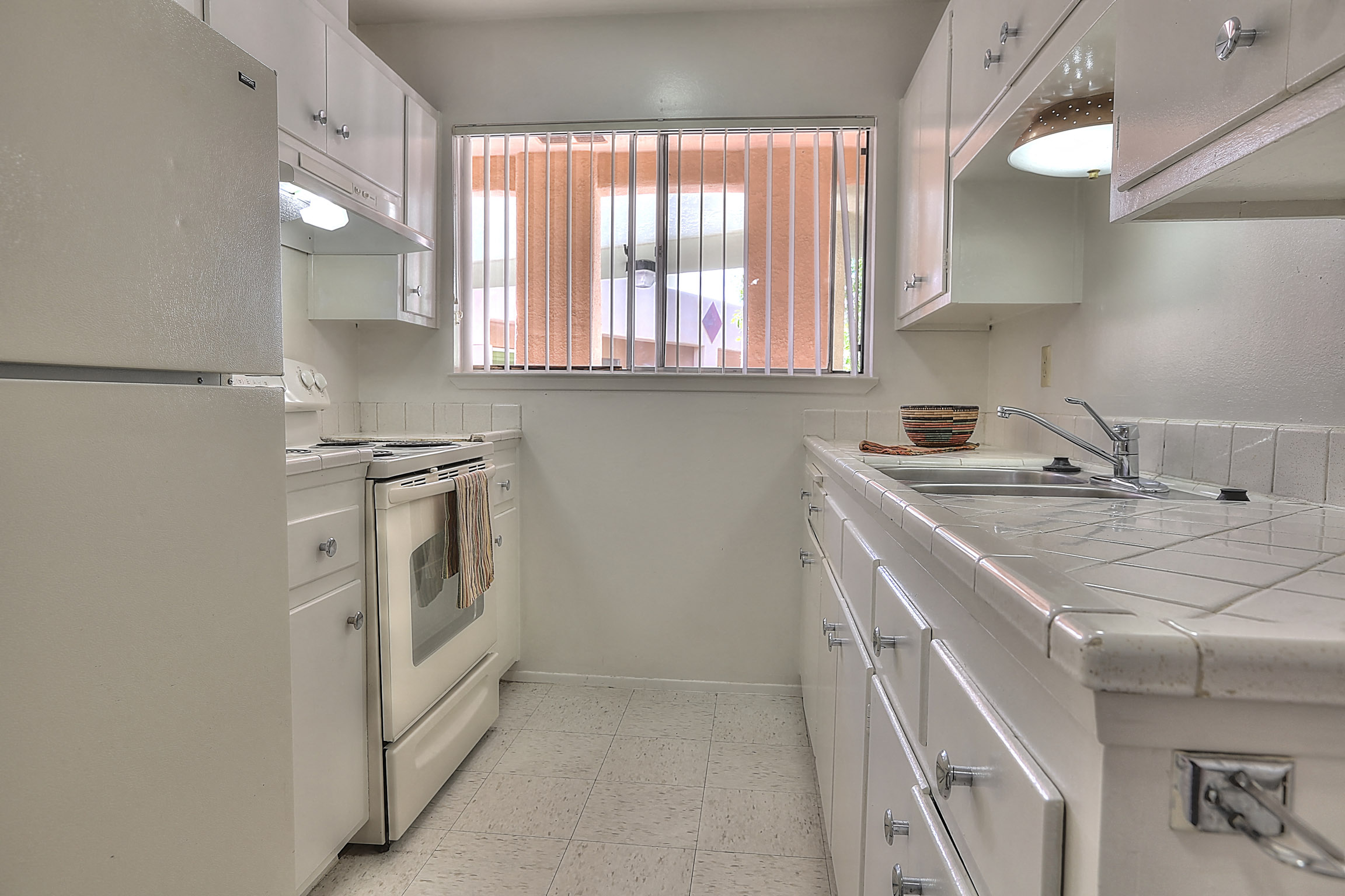 A white kitchen with a window.
