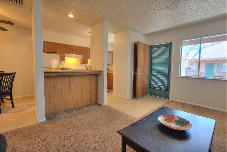 A kitchen with a dining table and chairs.