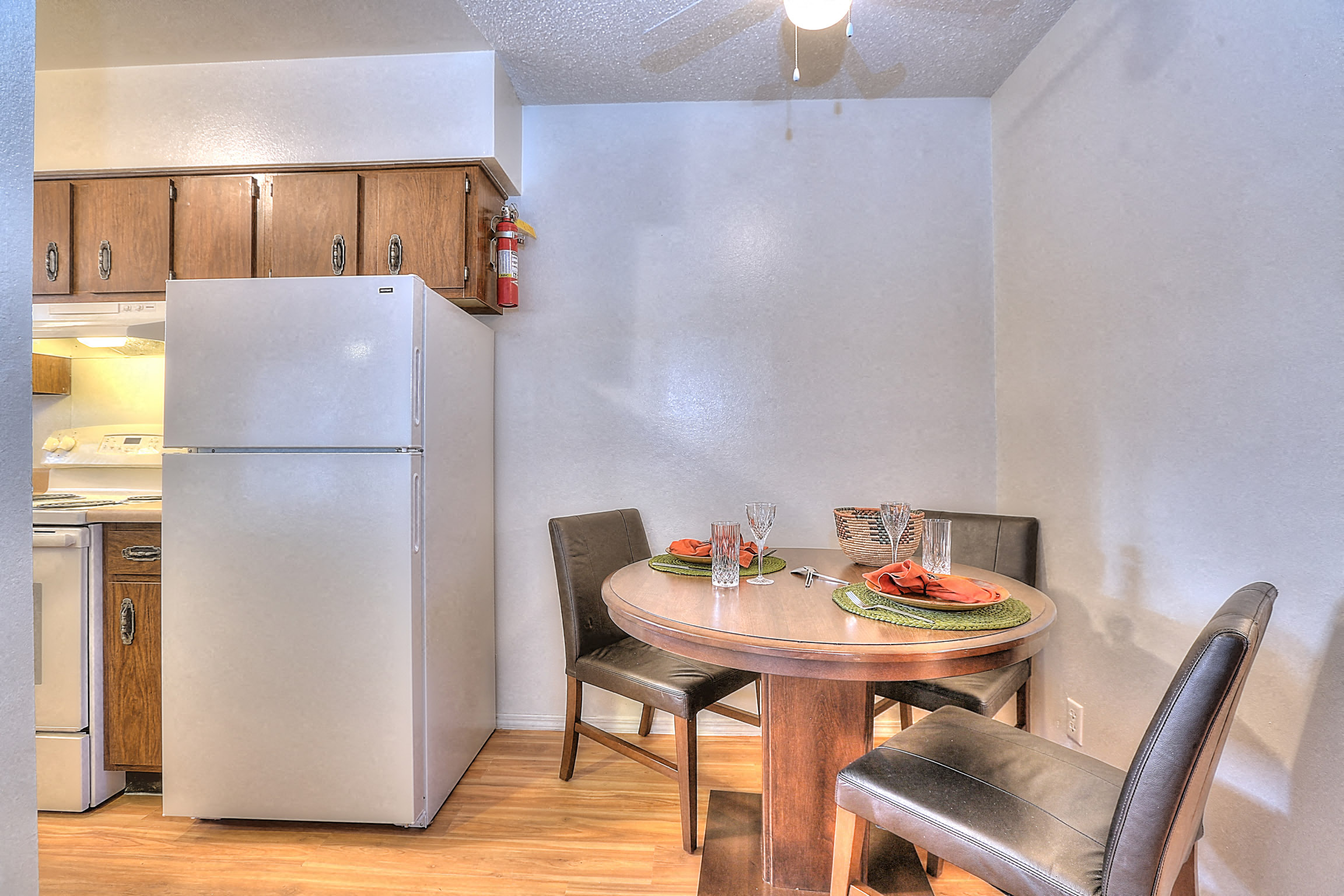 A kitchen with a table set for two.