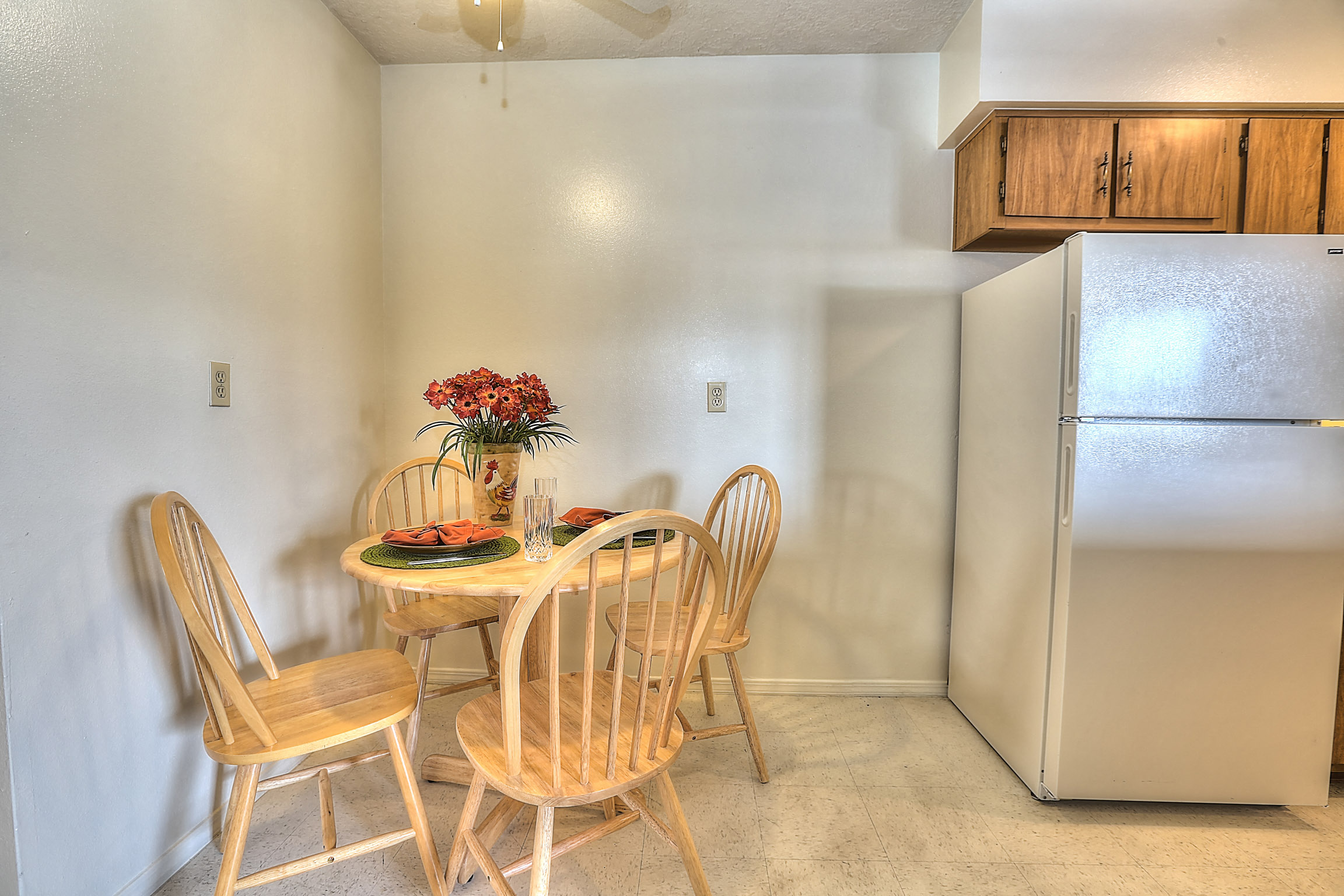 A kitchen with a table and chairs.