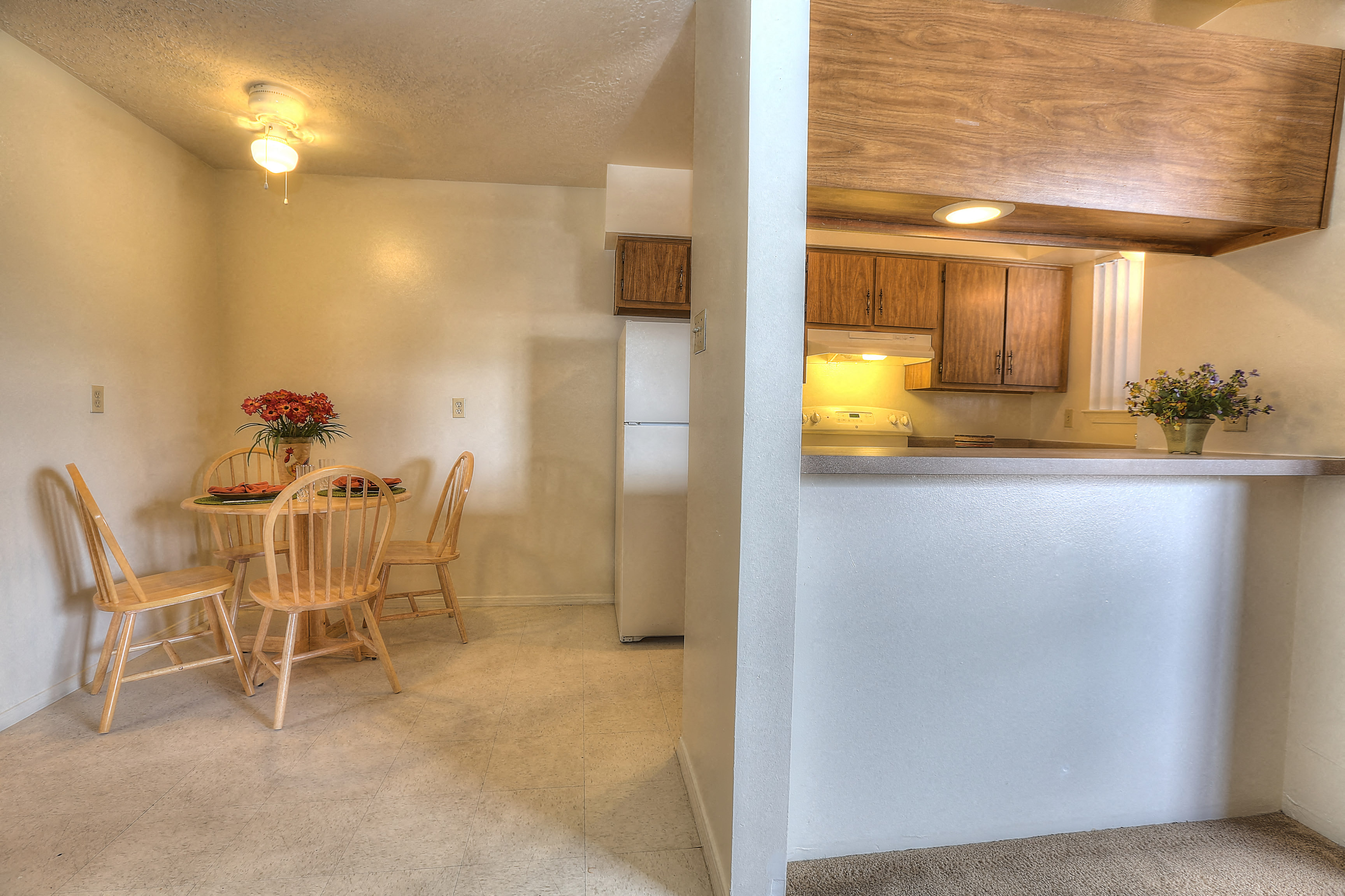 A dining room with a table and chairs.