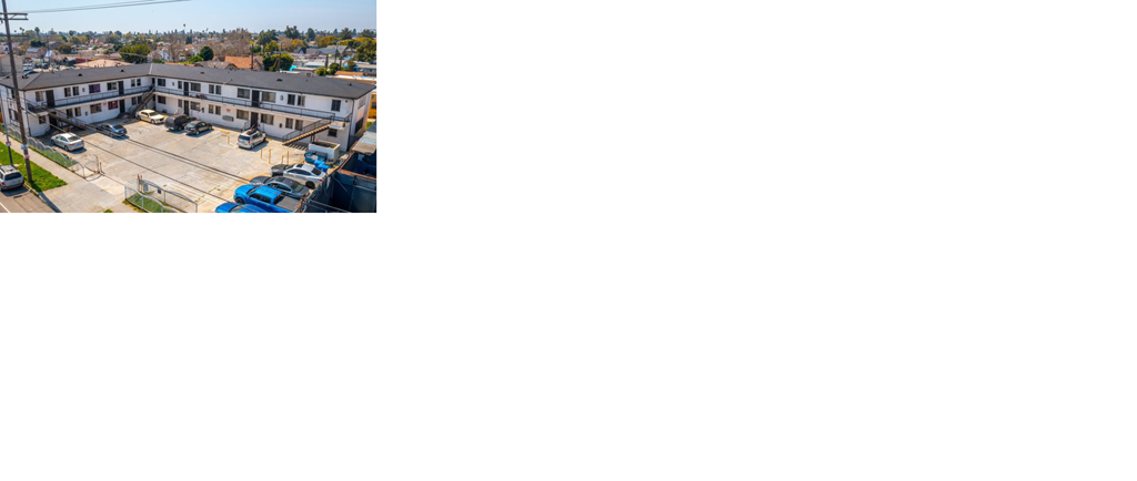 an aerial view of a building with a parking lot