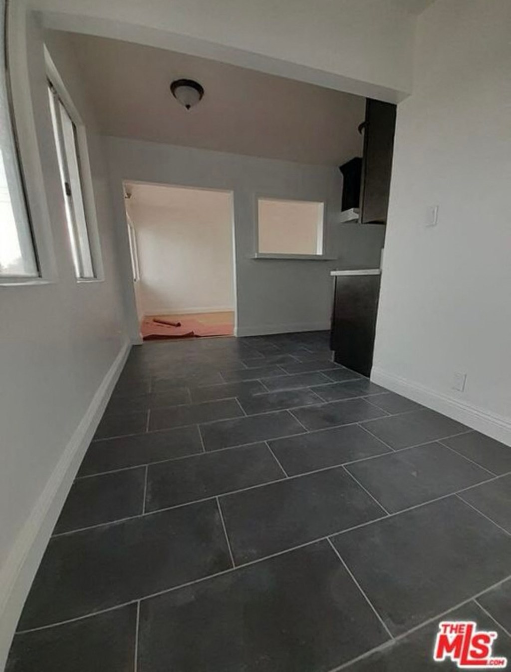 an empty room in a house with tiled flooring