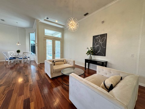 a living room with two couches and a glass coffee table