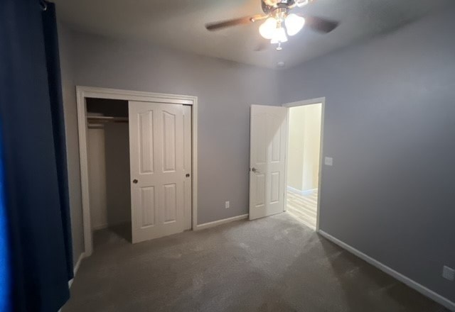 a empty room with two doors and a ceiling fan