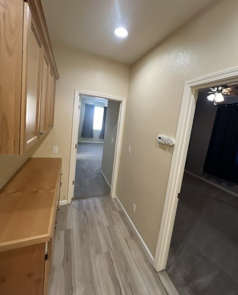 a hallway with a kitchen and a door to a hallway