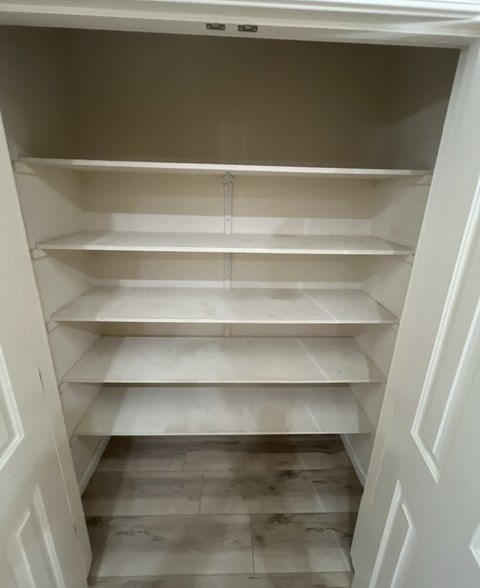 a white closet with empty shelves in it