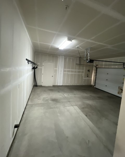 a room with a garage door and a white wall