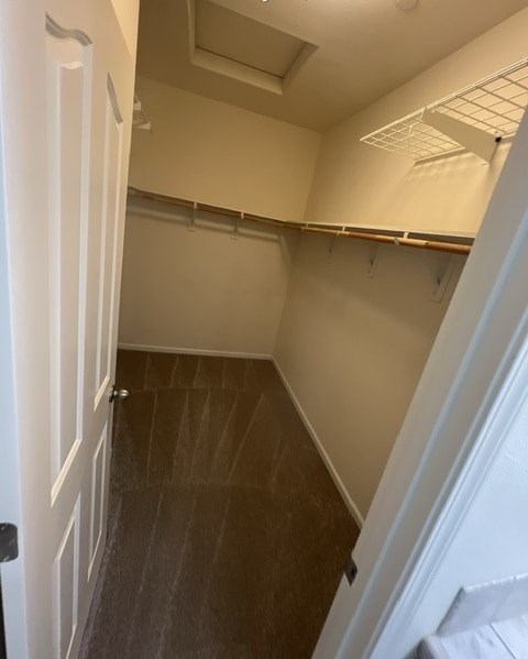 a small room with a closet and a white door