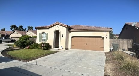 a house with a driveway and a garage door