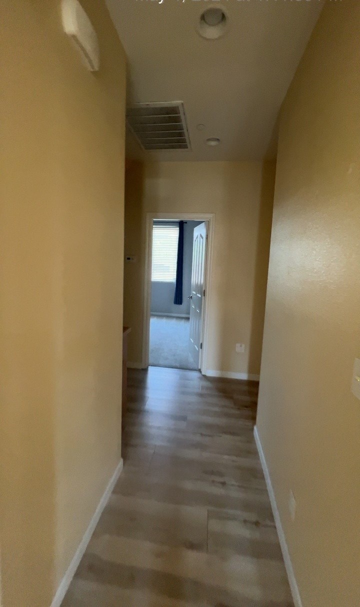 a view of the hallway from the living room looking into the bedroom and the bathroom