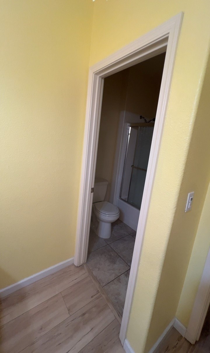 a bathroom with a toilet and a door way