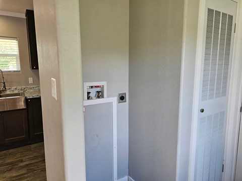 A white refrigerator in a kitchen with a white door.
