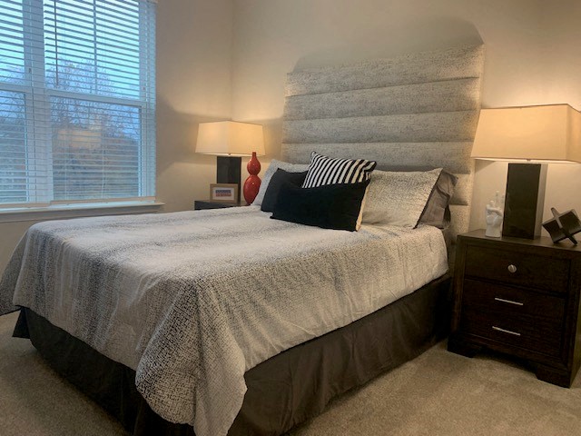 a bedroom with a bed and a large headboard