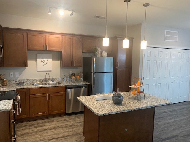 a kitchen with stainless steel appliances and granite counter tops