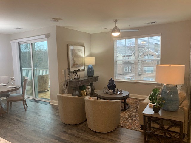 a living room with chairs and a table