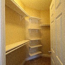 a small closet with shelves and a door