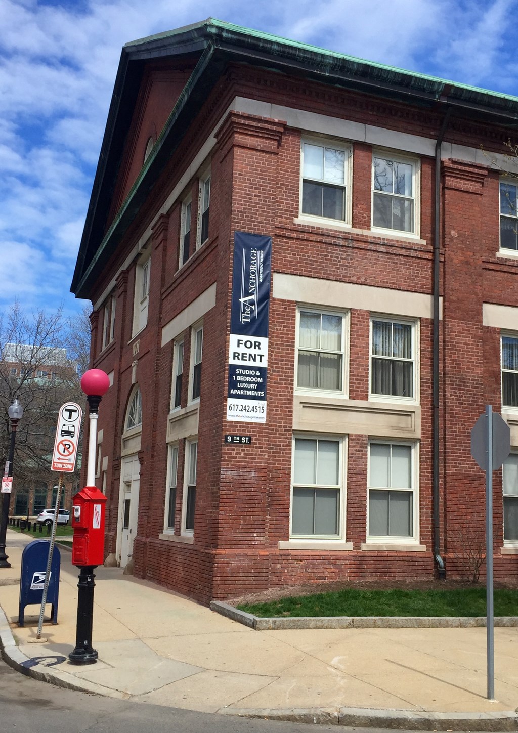 a red brick building with a sign on the side of it