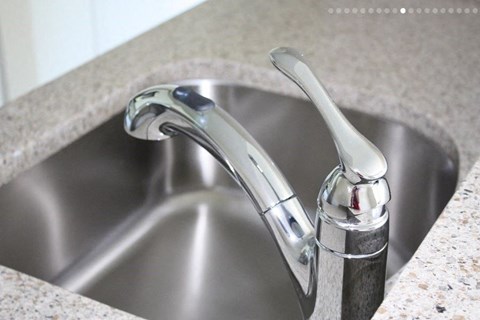 a kitchen sink with a faucet in it