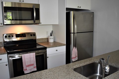a kitchen with stainless steel appliances and granite counter tops