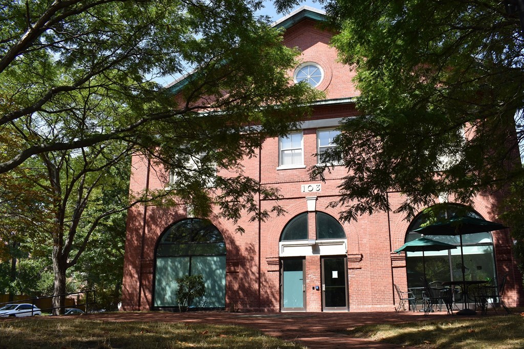 a red brick building with trees in front of it