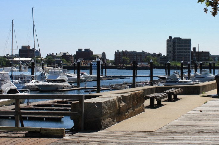 a dock with boats in the water at a marina